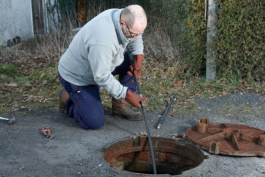 Man clearing the drains